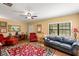 Spacious living room featuring wood floors, sofa, and ample natural light at 37713 Florida Ave, Dade City, FL 33525