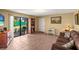 Comfortable living room featuring tile floors, sliding glass doors to the backyard, and neutral walls at 37713 Florida Ave, Dade City, FL 33525