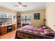 Bedroom with rustic details, wood floors, desk and bright natural light at 37713 Florida Ave, Dade City, FL 33525