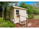 Outdoor shed with a window, door, and wooden steps, surrounded by greenery at 37713 Florida Ave, Dade City, FL 33525