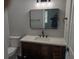 Updated bathroom featuring wood vanity, white quartz countertop, and modern fixtures at 402 Mary St, Punta Gorda, FL 33950