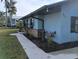 Street view of charming home with rock facade, flower boxes, and metal roof at 402 Mary St, Punta Gorda, FL 33950
