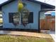 Street view of charming home with rock facade, flower boxes, and metal roof at 402 Mary St, Punta Gorda, FL 33950