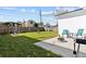 Spacious backyard with green grass, a swing set, patio, and space for outdoor entertaining at 4440 58Th N Ave, St Petersburg, FL 33714
