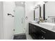 Modern bathroom with dual vanity, stylish black cabinets, and a glass-enclosed shower at 4440 58Th N Ave, St Petersburg, FL 33714