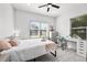 Bright bedroom featuring two windows, a ceiling fan, and a modern desk with a rolling chair at 4440 58Th N Ave, St Petersburg, FL 33714