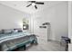 Cozy bedroom with a ceiling fan, a window, a closet, and light colored laminate floors at 4440 58Th N Ave, St Petersburg, FL 33714
