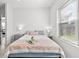Comfortable bedroom featuring two windows, a bedside table with drawers, and a light color scheme at 4440 58Th N Ave, St Petersburg, FL 33714