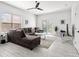 Bright living room features wood-look tile floors, a ceiling fan, and sliding doors to the backyard at 4440 58Th N Ave, St Petersburg, FL 33714