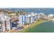 Aerial view of a condo building with waterfront access and lush landscaping, showcasing its scenic location at 500 Treasure Island Cswy # 207, Treasure Island, FL 33706
