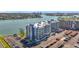 Aerial view showcasing condo buildings next to the water with a parking area at 500 Treasure Island Cswy # 207, Treasure Island, FL 33706