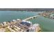 Aerial view showcasing condo buildings next to the water, featuring a nearby bridge at 500 Treasure Island Cswy # 207, Treasure Island, FL 33706