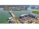 Aerial view showcasing condo buildings next to the water, featuring a nearby bridge at 500 Treasure Island Cswy # 207, Treasure Island, FL 33706