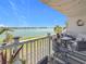 Enjoy views of the waterfront from this cozy condo balcony, complete with seating and charming decor at 500 Treasure Island Cswy # 207, Treasure Island, FL 33706