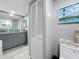 Bathroom featuring a granite countertop, modern cabinetry, a sink, mirror, and a toilet at 500 Treasure Island Cswy # 207, Treasure Island, FL 33706