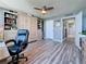 Bedroom featuring beautiful wood floors, a ceiling fan, built in storage, and an adjoining hall with a gray paint at 500 Treasure Island Cswy # 207, Treasure Island, FL 33706