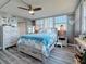 Charming bedroom with hardwood floors, closet, dresser, and coastal themed decor at 500 Treasure Island Cswy # 207, Treasure Island, FL 33706