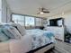 Cozy bedroom with a beach themed blanket, decorative pillows, a ceiling fan and a window with view at 500 Treasure Island Cswy # 207, Treasure Island, FL 33706