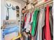 Walk in closet featuring shelving, hangers, clothes, hats, boxes, and a door at 500 Treasure Island Cswy # 207, Treasure Island, FL 33706