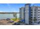 Condo building next to the water with parking and grass area at 500 Treasure Island Cswy # 207, Treasure Island, FL 33706