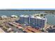 Waterfront condo building with a parking area, bay views and a bridge connecting to other land at 500 Treasure Island Cswy # 207, Treasure Island, FL 33706