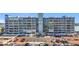 Condo building with balconies, palm trees, and parking spaces at 500 Treasure Island Cswy # 207, Treasure Island, FL 33706