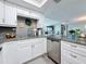 Renovated kitchen featuring stainless steel dishwasher and granite countertops at 500 Treasure Island Cswy # 207, Treasure Island, FL 33706