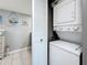 Space-saving laundry closet with a stacked washer and dryer unit at 500 Treasure Island Cswy # 207, Treasure Island, FL 33706