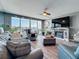 Comfortable living room with a fireplace, flat screen tv, ample seating, and scenic views of the water at 500 Treasure Island Cswy # 207, Treasure Island, FL 33706
