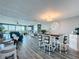 Open-concept living area with water views, luxury vinyl plank flooring, and a glimpse of the dining area at 500 Treasure Island Cswy # 207, Treasure Island, FL 33706