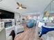 Open floor plan with living and dining areas connected, offering a cohesive and stylish space with a fireplace at 500 Treasure Island Cswy # 207, Treasure Island, FL 33706
