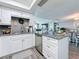 Open-concept living space featuring luxury vinyl plank flooring, stainless steel appliances and granite countertops at 500 Treasure Island Cswy # 207, Treasure Island, FL 33706