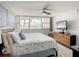 Cozy main bedroom featuring a large window, ceiling fan, and relaxing atmosphere at 500 Treasure Island Cswy # 207, Treasure Island, FL 33706