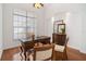 Well-lit home office with hardwood floors, a classic desk setup, and traditional wooden accents at 5021 Championship Cup Ln, Spring Hill, FL 34609