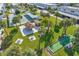 Aerial view of the community amenities featuring pool, tiki hut, bocce ball court, and lush landscaping at 5246 81St N St # 24, St Petersburg, FL 33709