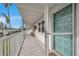 Condo balcony showcasing a white railing and a light blue entry door with views of the community at 5246 81St N St # 24, St Petersburg, FL 33709