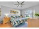 Inviting bedroom with natural light, wood floors, and a colorful leaf-themed bedspread at 6025 112Th N Ave, Pinellas Park, FL 33782