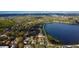 Aerial view of a quaint home nestled in a lush neighborhood with a lake and mature trees nearby at 715 Virginia Ave, Tarpon Springs, FL 34689