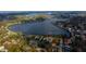 Aerial view showing proximity to a beautiful lake with boating access in a neighborhood with mature landscaping at 715 Virginia Ave, Tarpon Springs, FL 34689