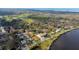 Aerial view of a charming neighborhood with homes near the water and a green golf course in the background at 715 Virginia Ave, Tarpon Springs, FL 34689