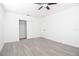 Clean bedroom featuring wood-look flooring, ceiling fan, and closet at 715 Virginia Ave, Tarpon Springs, FL 34689