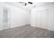 Bright bedroom featuring wood-look floors, and ensuite bath with a large closet at 715 Virginia Ave, Tarpon Springs, FL 34689