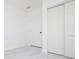 Bedroom with light gray floors, white closet, and doors at 715 Virginia Ave, Tarpon Springs, FL 34689