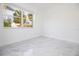 Bright bedroom featuring light gray flooring and a window providing natural light at 715 Virginia Ave, Tarpon Springs, FL 34689