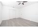 Spacious bedroom with neutral paint, wood-look flooring, and a closet at 715 Virginia Ave, Tarpon Springs, FL 34689