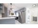 Modern kitchen with gray cabinets, stainless steel appliances, and a breakfast bar with stylish pendant lighting at 715 Virginia Ave, Tarpon Springs, FL 34689