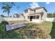 Large backyard featuring a covered patio with a built-in outdoor kitchen and a concrete pad at 7525 Forest Mere Dr, Riverview, FL 33578