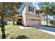 Two-story home featuring a two-car garage and manicured front yard at 7525 Forest Mere Dr, Riverview, FL 33578