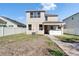 Back exterior view of the two-story home featuring a covered patio with an outdoor kitchen at 7525 Forest Mere Dr, Riverview, FL 33578