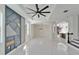 Spacious living room featuring high ceilings, a modern ceiling fan, and white tile flooring at 7525 Forest Mere Dr, Riverview, FL 33578